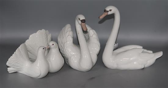 A group of two Lladro swans and two doves